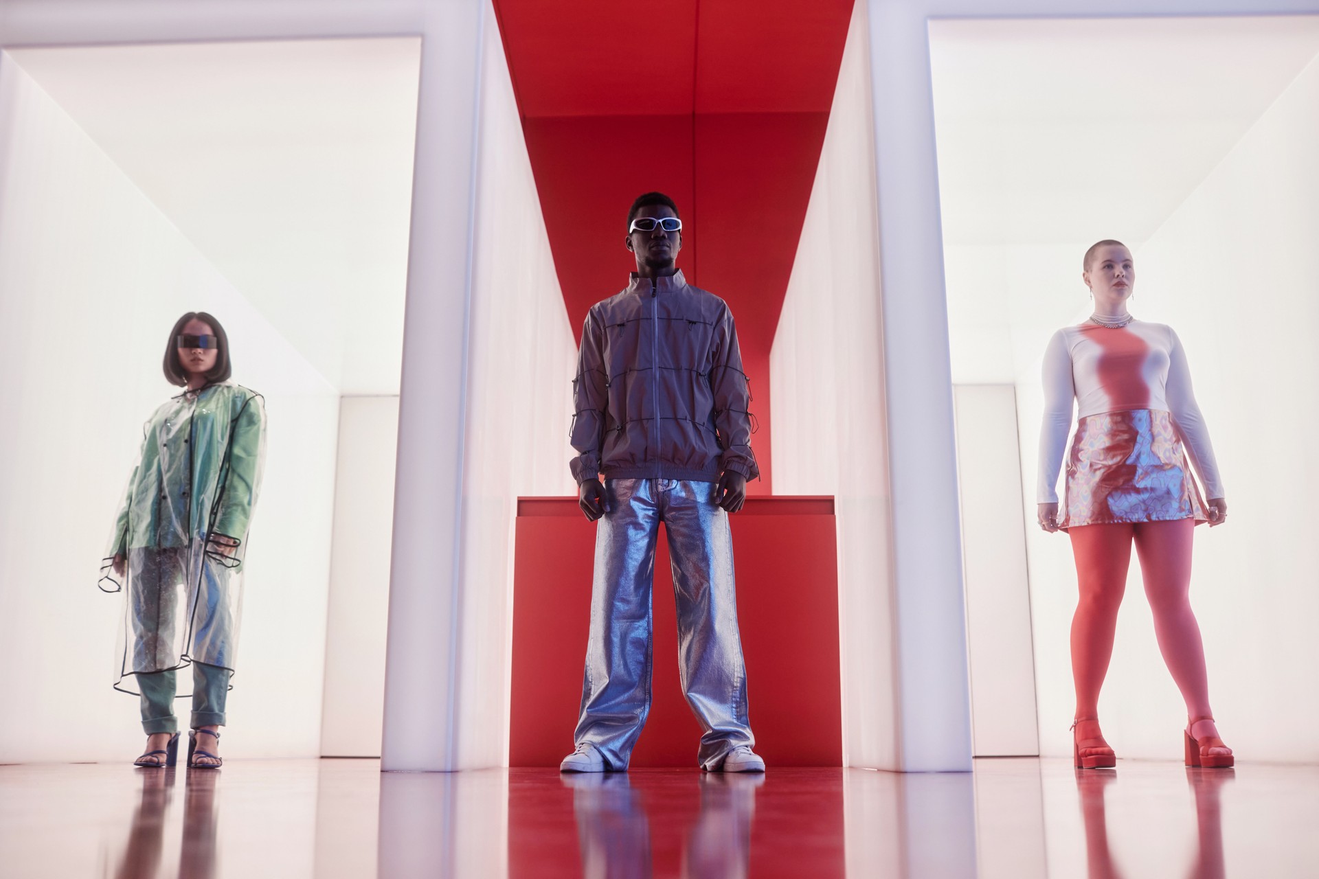 People posing in futuristic outfits standing in row