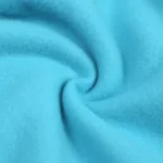 Close-up of premium baby joggers fabric, featuring ultra-soft 100% cotton French Terry, high-density breathable fleece, and vibrant eco-friendly dyeing. Professional infant apparel textile from a leading clothing manufacturer.