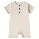 Custom beige baby romper, featuring short sleeves, front wood-look buttons, and snap closure for easy diaper changes. Premium soft cotton infant sunsuit from a professional OEM/ODM clothing manufacturer.