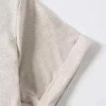 Close-up of baby romper leg opening detail, featuring precision flat-lock stitching, soft-stretch cotton jersey fabric