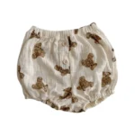 Custom baby muslin bloomers with cute bear print, featuring decorative wooden buttons, breathable double gauze infant diaper cover, professional OEM/ODM kids boutique clothing manufacturer.