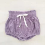 Custom purple baby bloomers, elegant muslin cotton diaper cover, trendy ruffle trim infant shorts with white drawstring, professional OEM/ODM baby clothing manufacturer in China.