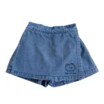 Custom denim-blue baby skort, featuring a skirt-and-shorts-in-one design, soft stretch fabric, and cute minimalist bear print. Premium infant girl's summer apparel from a professional OEM/ODM clothing manufacturer.
