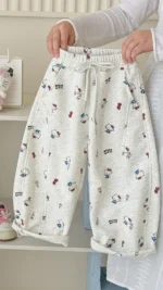 Custom white girls' pants with all-over pattern print, comfortable toddler loose fit trousers, professional OEM/ODM kids' clothing manufacturer.