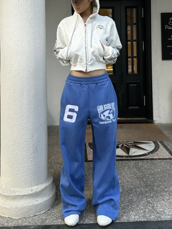 Blue custom sweatpants with white number prints and a matching cropped hoodie, produced by an OEM/ODM streetwear manufacturer.