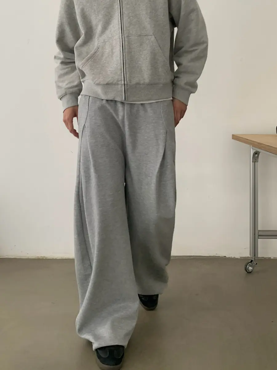 Grey wide-leg trousers with a minimalist relaxed fit, produced by a professional custom apparel manufacturer.