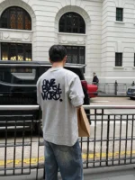 Custom grey mens T-shirt with large back embroidery, high-density lettering embroidered streetwear tee, premium heavyweight cotton apparel from a professional OEM/ODM garment manufacturer.