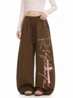 Custom brown wide leg sweatpants with pink graphic lettering print, oversized baggy joggers for women, professional OEM/ODM clothing manufacturer.