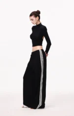 Custom black wide leg pants with white side stripes, elegant athleisure trousers for women, high-quality apparel manufacturing and OEM services.