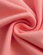 Premium Xinjiang cotton fabric for custom T-shirts, soft pink combed cotton jersey, high-quality long-staple cotton apparel from a professional OEM/ODM garment manufacturer.