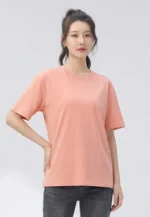 Custom coral orange womens T-shirt, classic crew neck short sleeve tee, high-quality combed cotton jersey apparel from a professional OEM/ODM ladies' clothing manufacturer in China.
