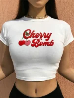 Custom white womens baby tee with "Cherry Bomb" graphic print, trendy slim fit cropped T-shirt, premium Y2K style ladies' apparel manufacturer in China.