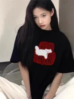 Custom black womens oversized T-shirt with cute polar bear and red polka dot heart print, trendy graphic tee for women, professional OEM/ODM ladies' clothing manufacturer in China.