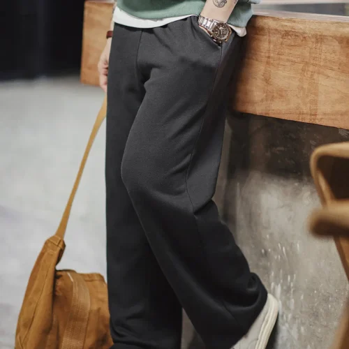 Black mens straight-leg trousers with a relaxed fit, produced by a professional custom clothing manufacturer.