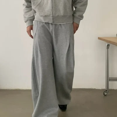 Grey wide-leg trousers with a minimalist relaxed fit, produced by a professional custom apparel manufacturer.