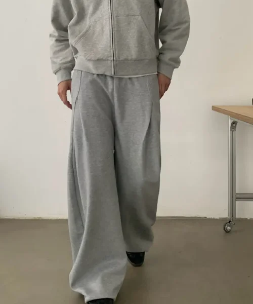 Grey wide-leg trousers with a minimalist relaxed fit, produced by a professional custom apparel manufacturer.