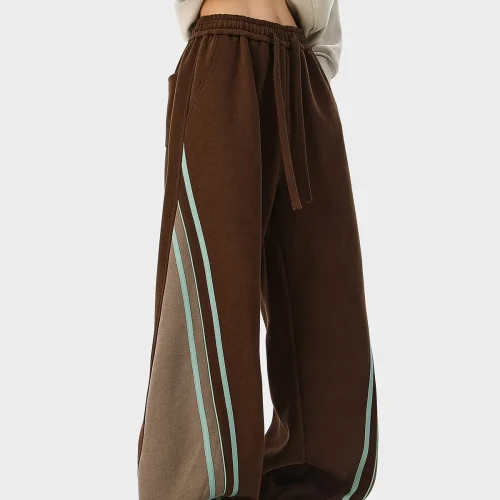 Brown wide-leg track pants with side stripe details and color-blocking, produced by an OEM/ODM streetwear manufacturer.